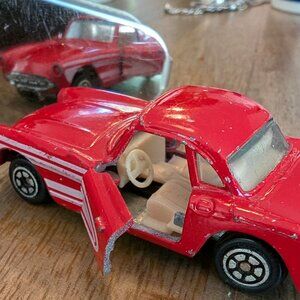vintage diecast toy car, specifically a red 1957 Chevrolet Corvette, model numbe
